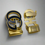 Gold and black belt buckle on a white background